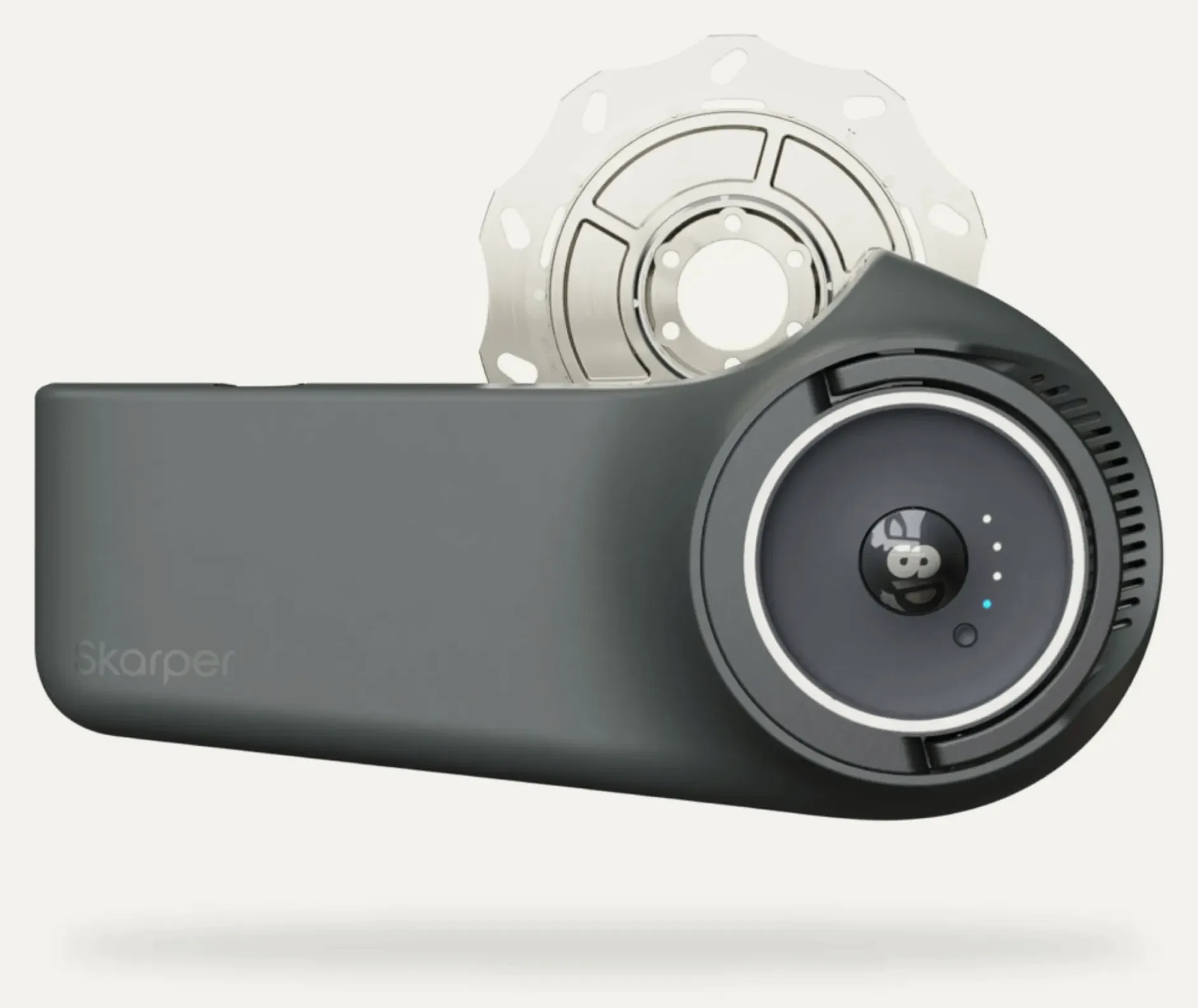 The Skarper drive unit: a grey body with a round disc carrying a lens, status lights and a button